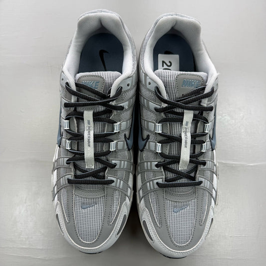 Nike grey trainers with blue accents and mesh material, featuring iconic swoosh logo.