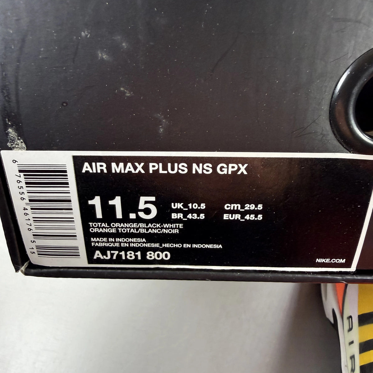 Nike Air Max Plus trainers total orange with large logo and mesh material.
