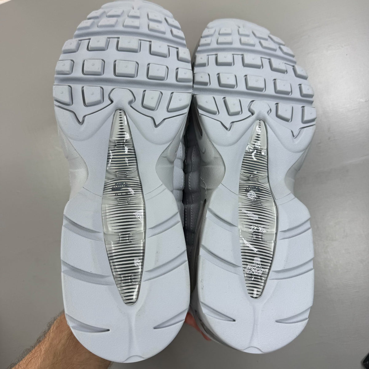 Nike Air Max 95 white trainers with big bubble sole and reflective detailing.