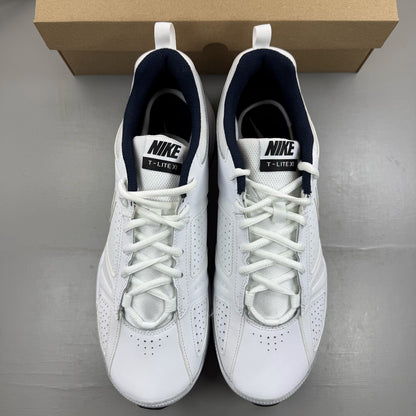 Nike white running trainers with black and navy accents, featuring logo details.