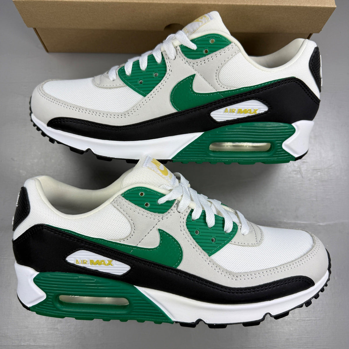 Nike trainers white with malachite and black accents, featuring iconic Air Max design.
