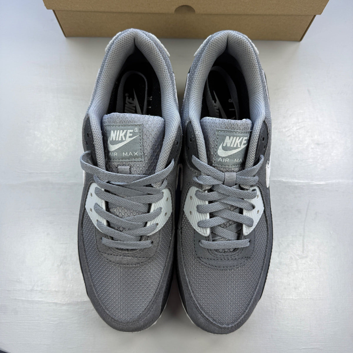 Nike trainers grey with black accents and logo, featuring a sleek design and breathable material.