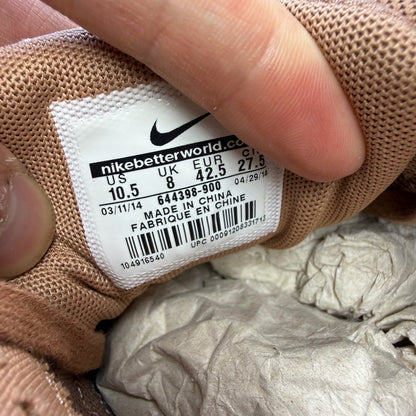 Nike Air Max 1 white trainers with bronze snake print and metallic accents.