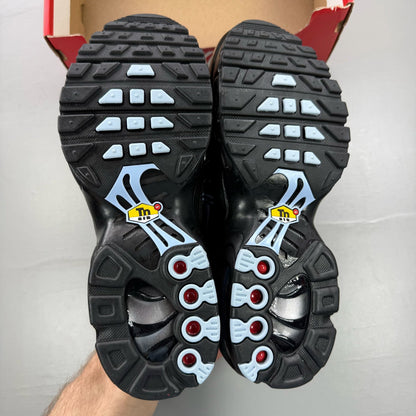 Nike Air Max Plus TN Tuned black trainers with grey accents and signature logo.