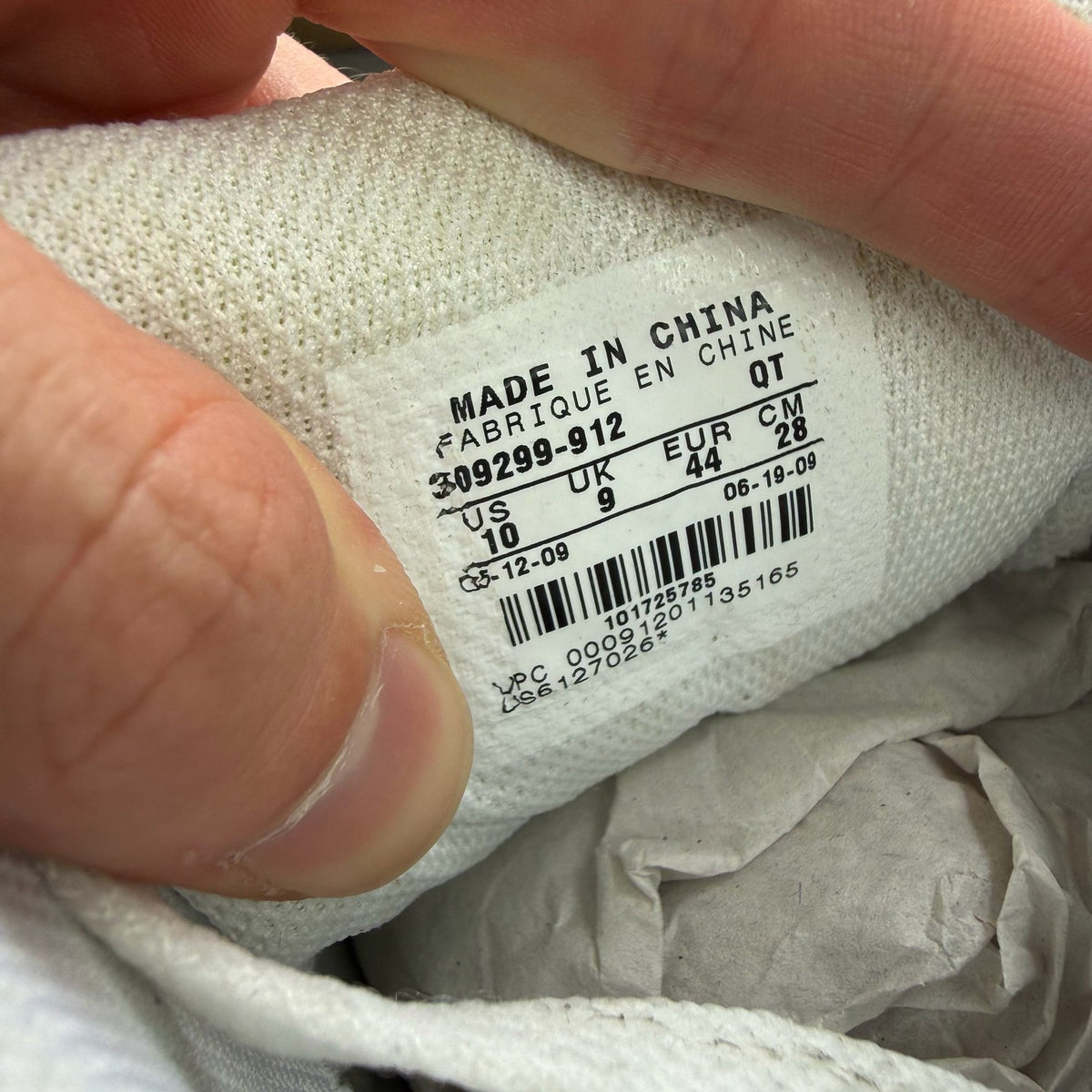 Nike Air Max 90 white trainers with grey accents and logo detailing.