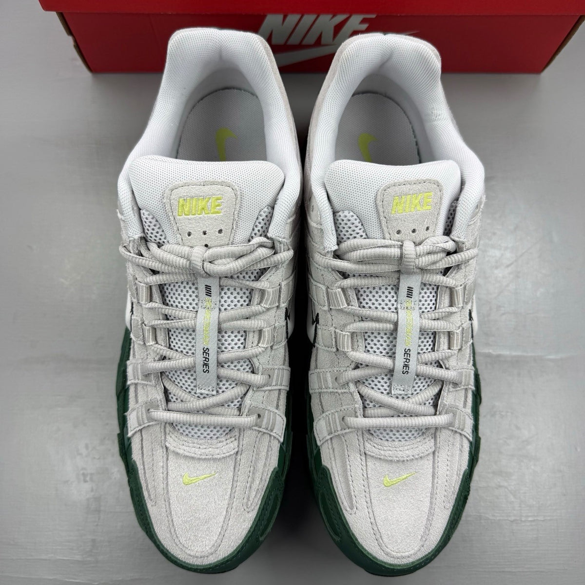 Nike P-6000 grey trainers with mesh upper and signature swoosh logo.