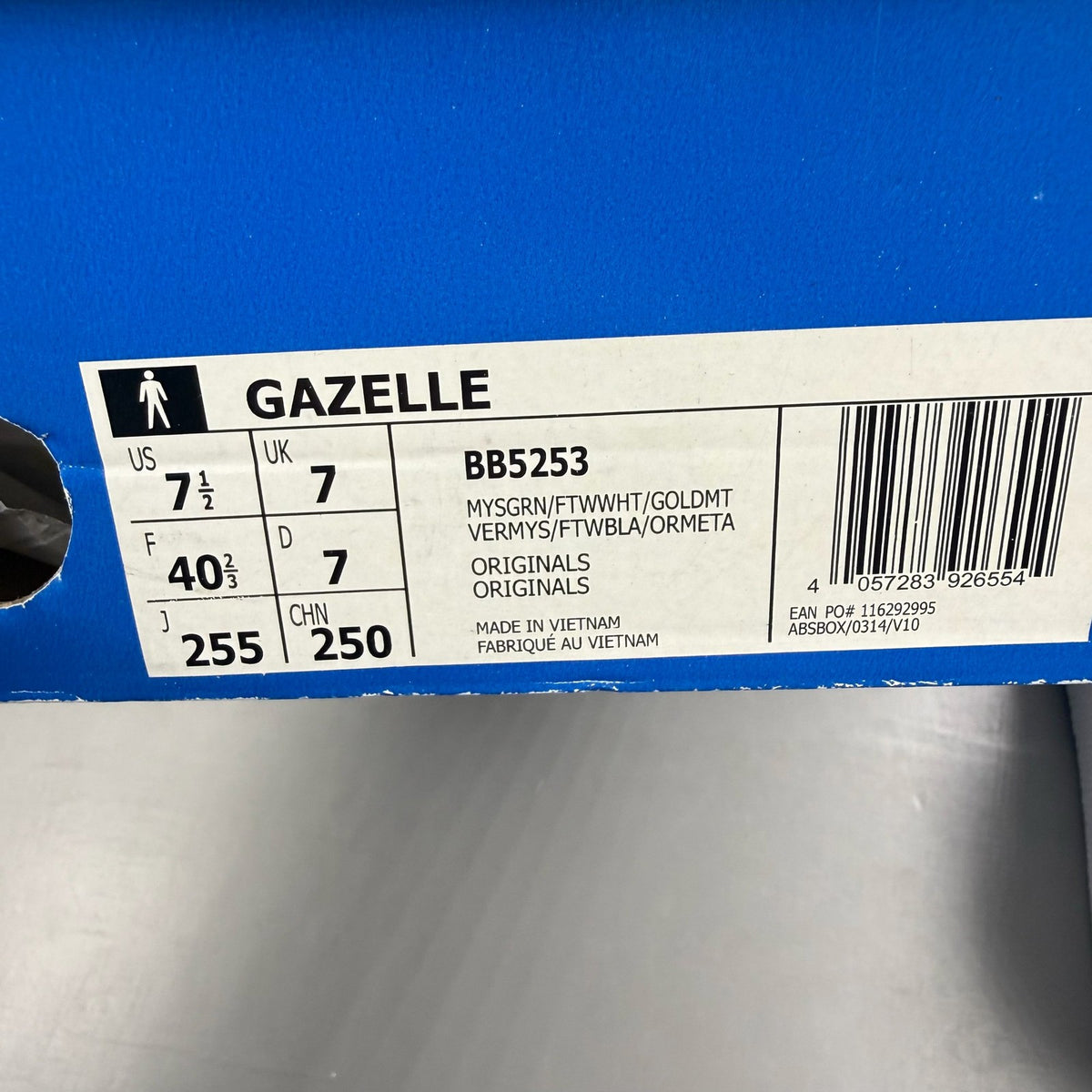 Adidas green suede Gazelle trainers with white stripes and logo detail.