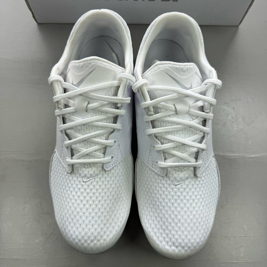 Nike white trainers with gum sole and silver accents, featuring breathable mesh upper.