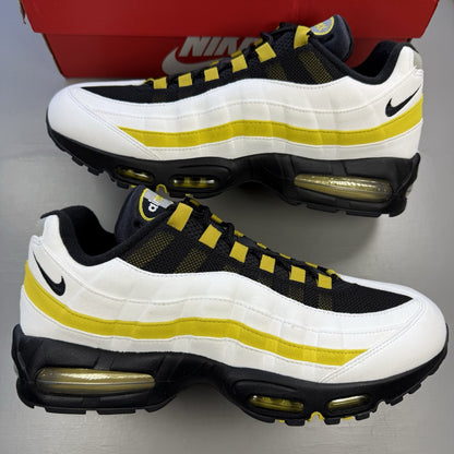 Nike Air Max 95 trainers black with white and saffron accents, featuring iconic logo.