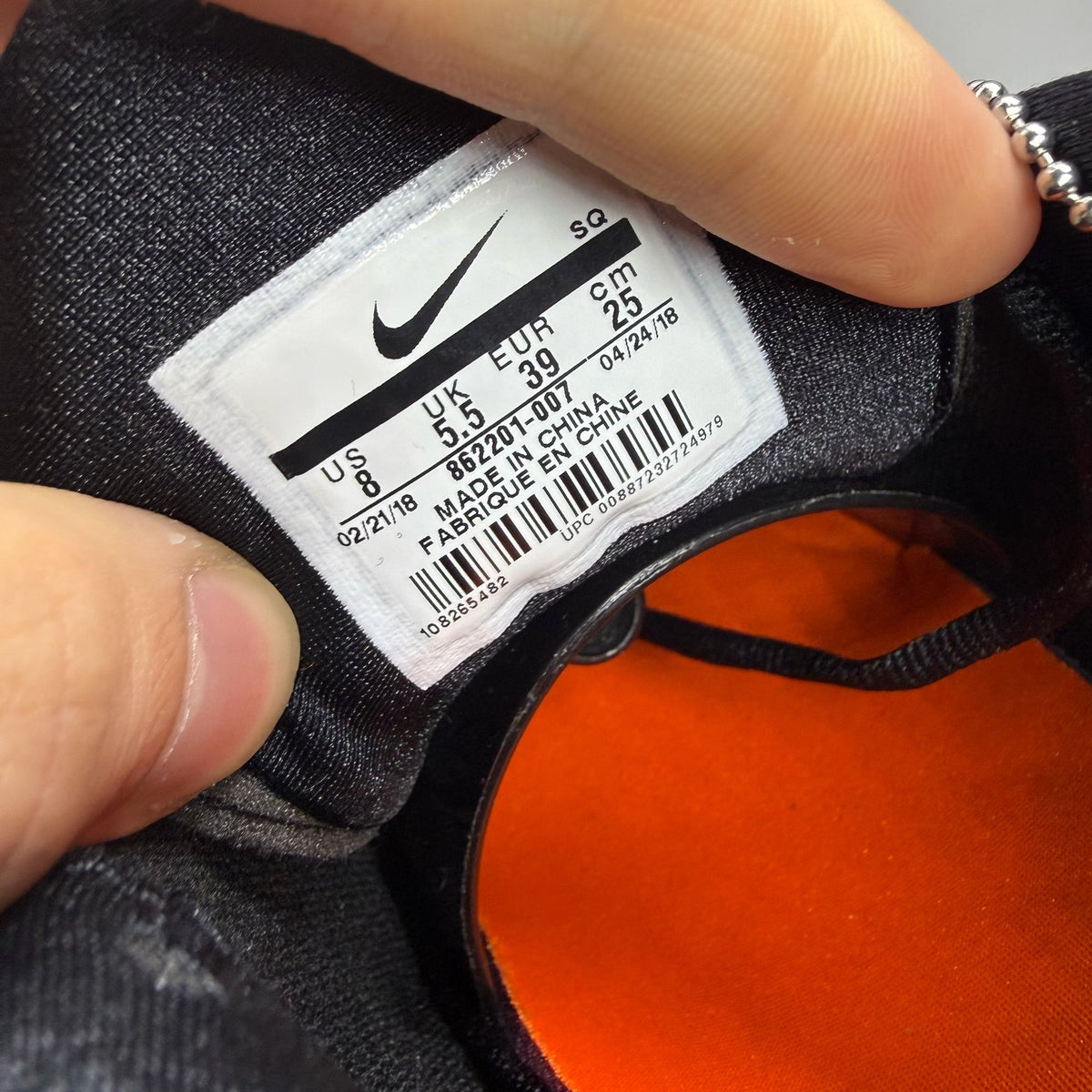 Nike black trainers featuring the Just Do It logo and sleek design.