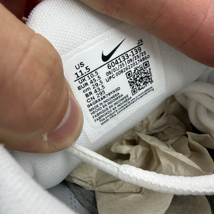 Nike Air Max Plus TN white trainers with grey accents and signature swoosh logo.