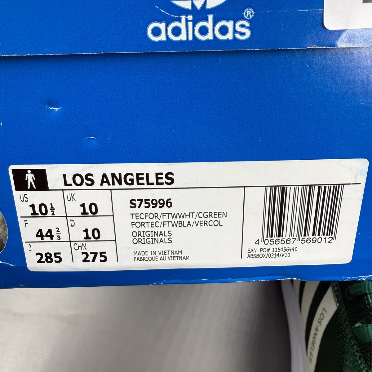 Adidas green trainers with white accents and logo detailing, brand new in box.