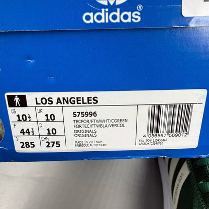Adidas green trainers with white accents and logo detailing, brand new in box.