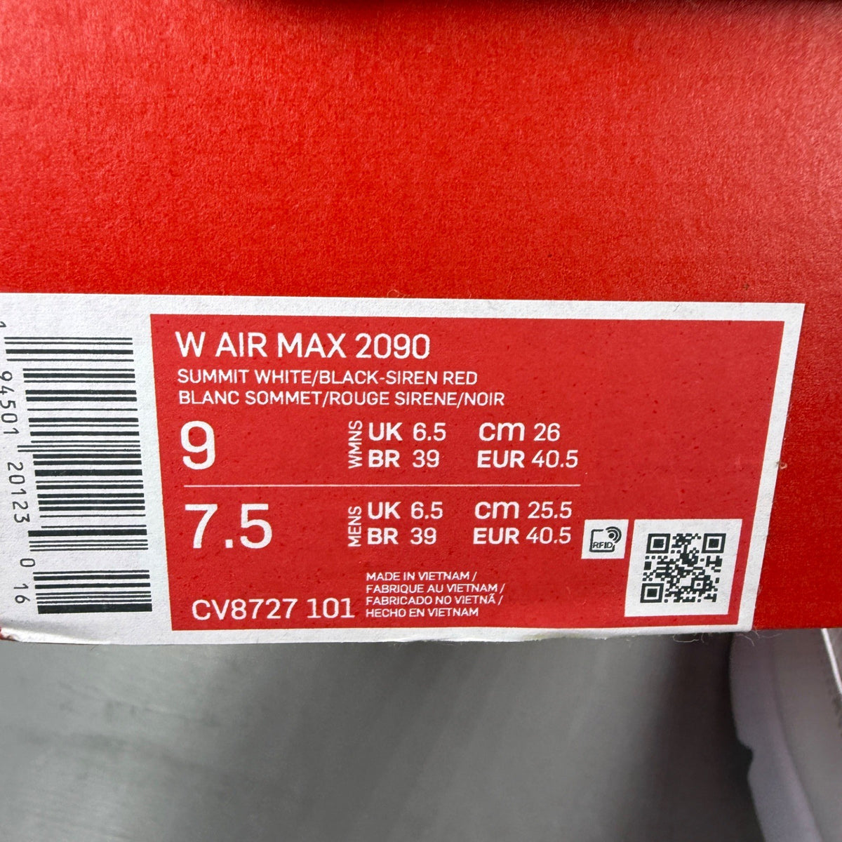 Nike running shoes white with red accents and logo, featuring a sleek design.
