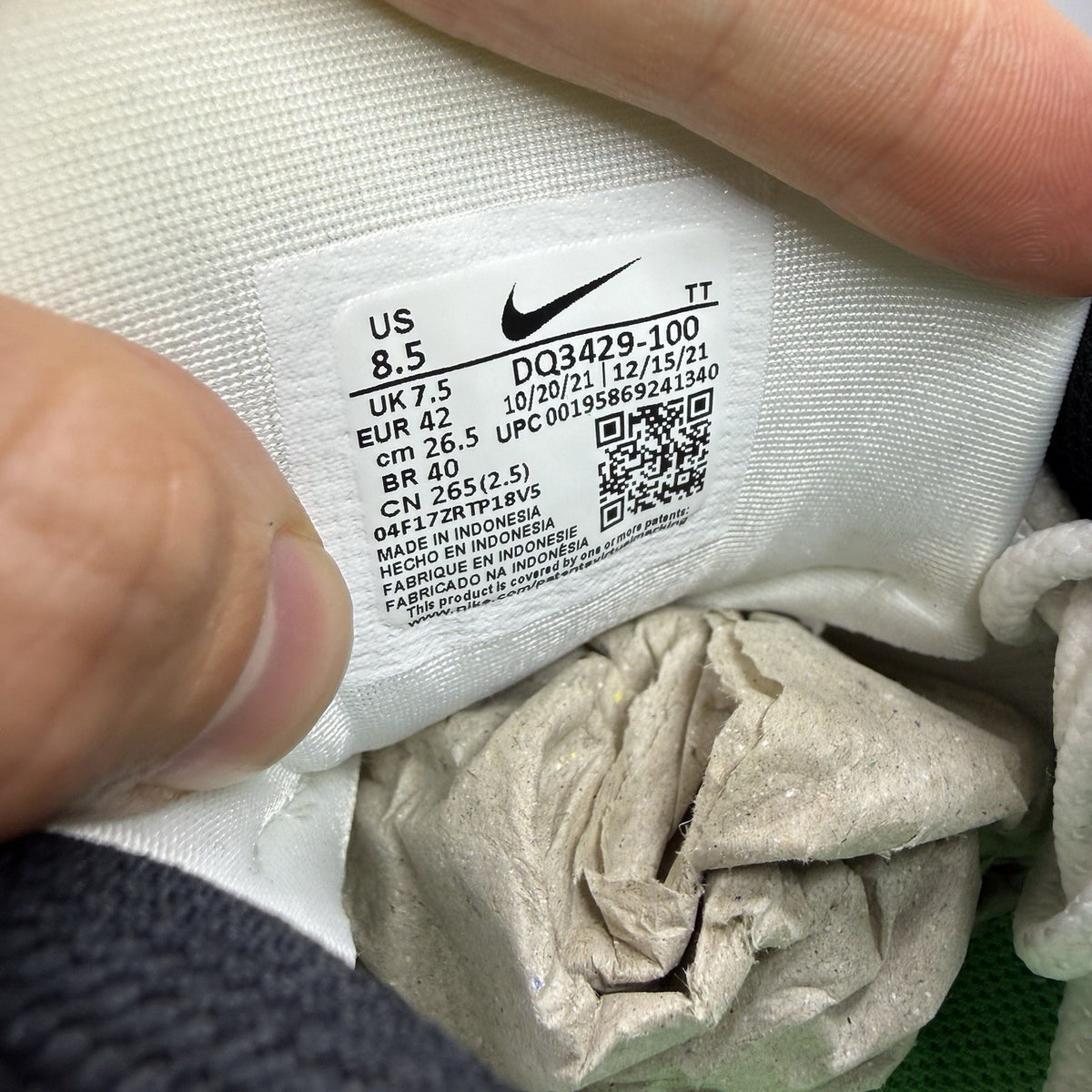 Nike Air Max 95 white trainers with green and yellow accents, featuring iconic logo details.