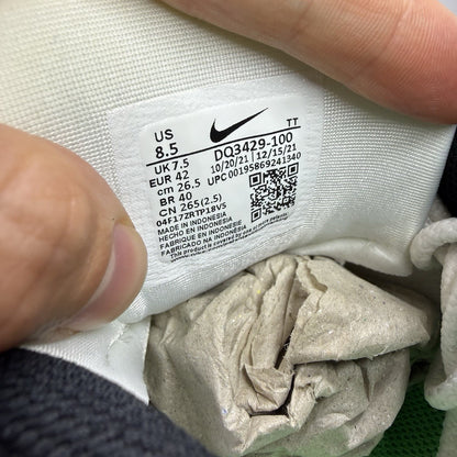 Nike Air Max 95 white trainers with green and yellow accents, featuring iconic logo details.