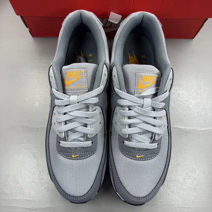 Nike Air Max 90 grey trainers with black and sundial accents, featuring logo details.