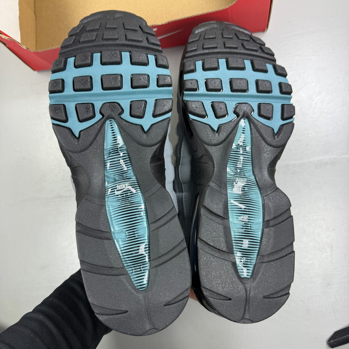 Nike running shoes grey with big bubble sole and reflective detailing.