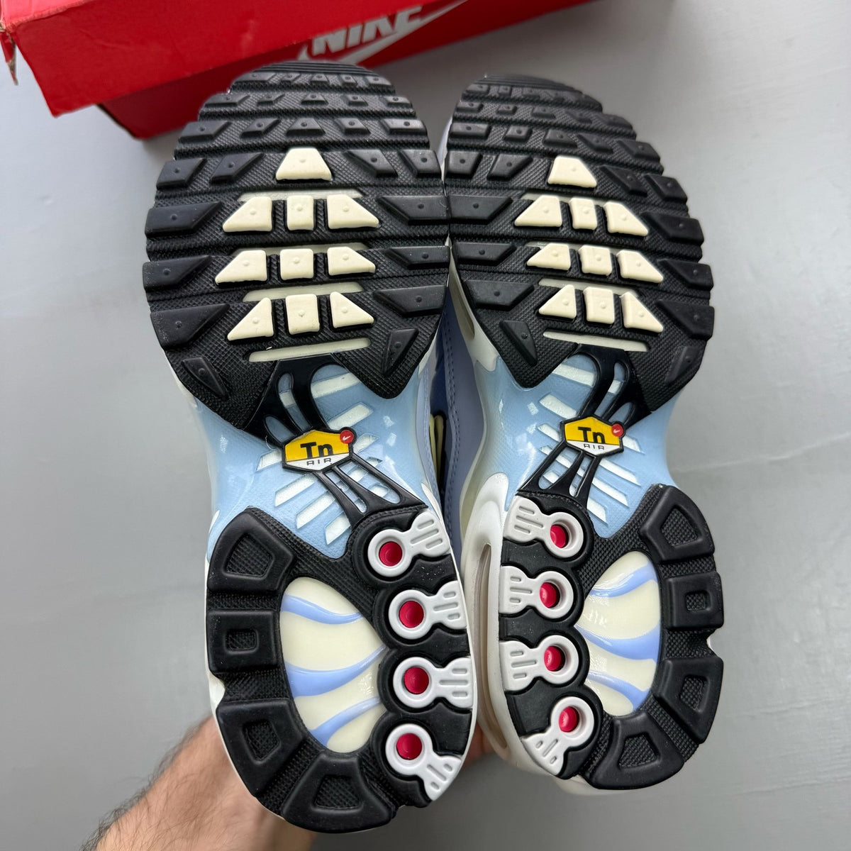 Nike Air Max Plus TN blue trainers with signature logo and sleek design.