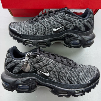Nike black trainers suede material with silver accents and iconic Air Max Plus design.