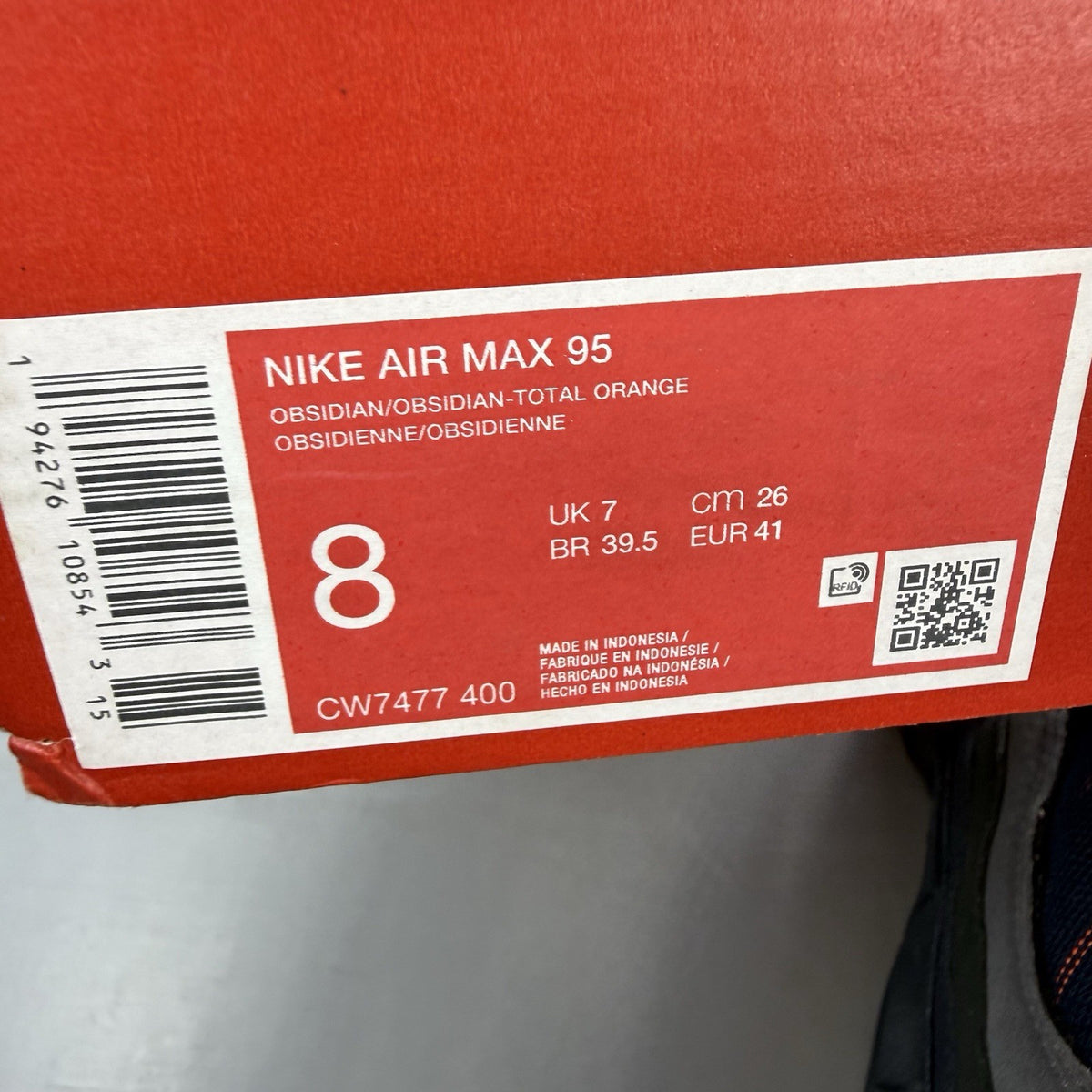 Nike Air Max 95 trainers navy blue with orange accents and anthracite grey details.