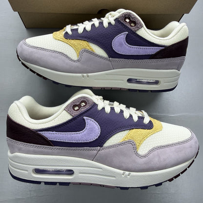Nike Air Max 1 87 trainers grey with violet accents and signature swoosh logo.