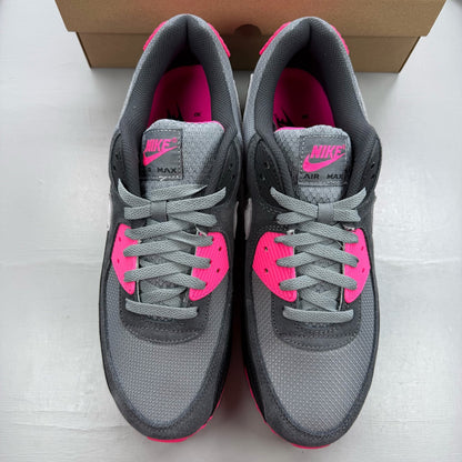 Nike Air Max 90 grey trainers with hyper pink accents and black detailing.