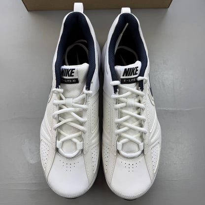 Nike white trainers with navy and black accents, featuring logo detailing and mesh material.