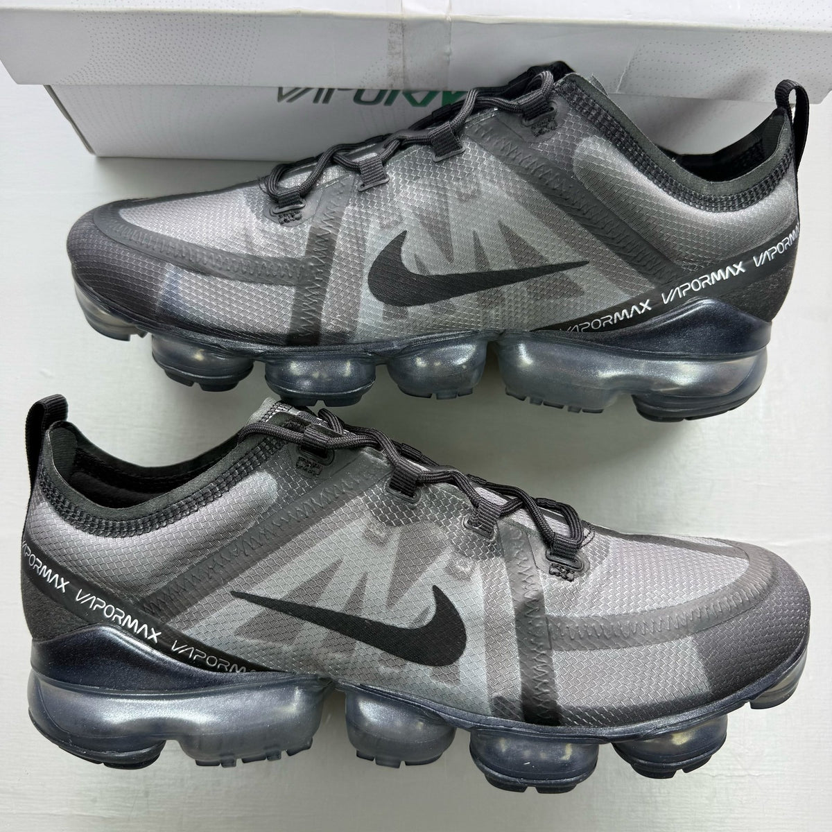 Nike Air VaporMax 2019 black trainers with distinctive air cushioning and sleek design.