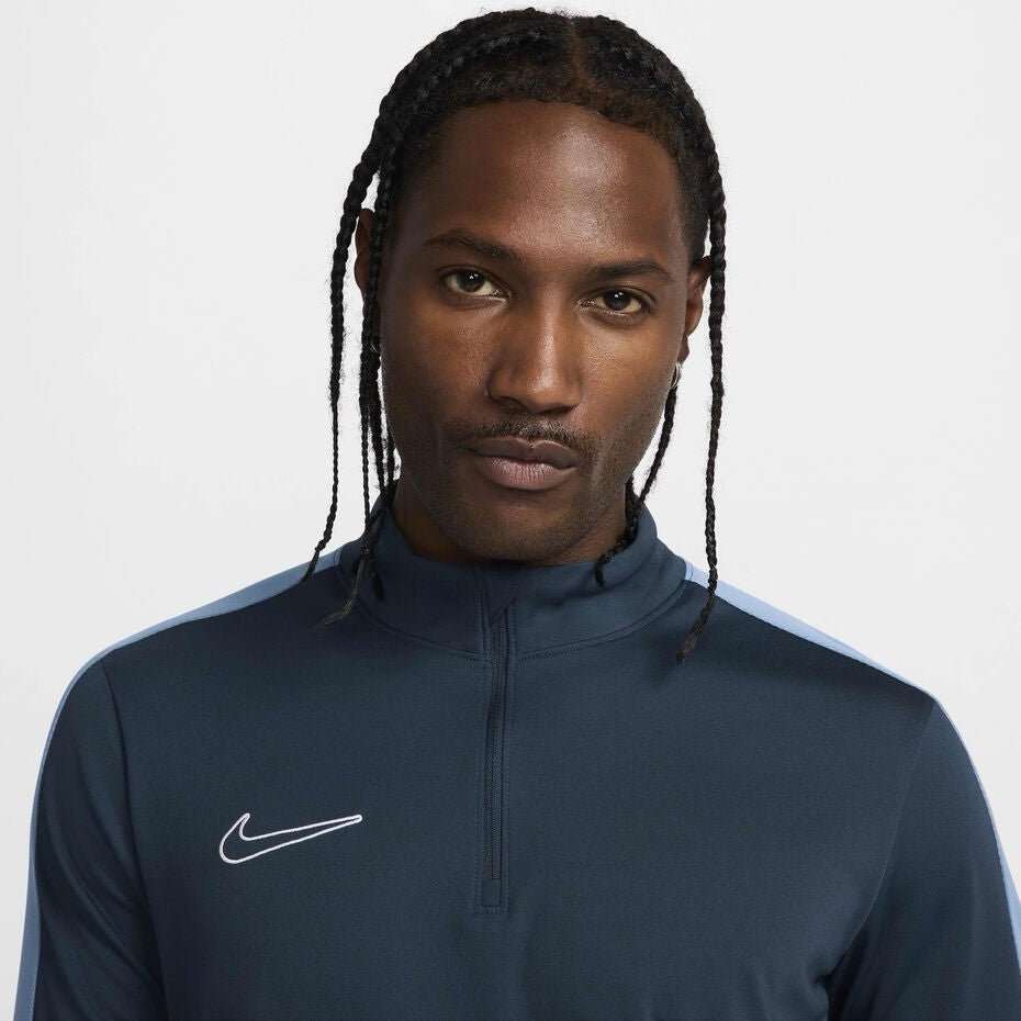 Nike blue Dri-FIT 1/4 zip top with logo and breathable material.