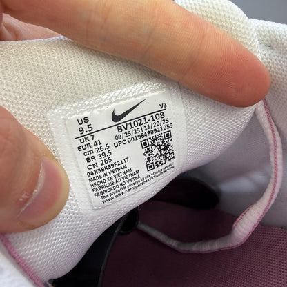 Nike white trainers with elemental pink and silver accents, featuring logo details.