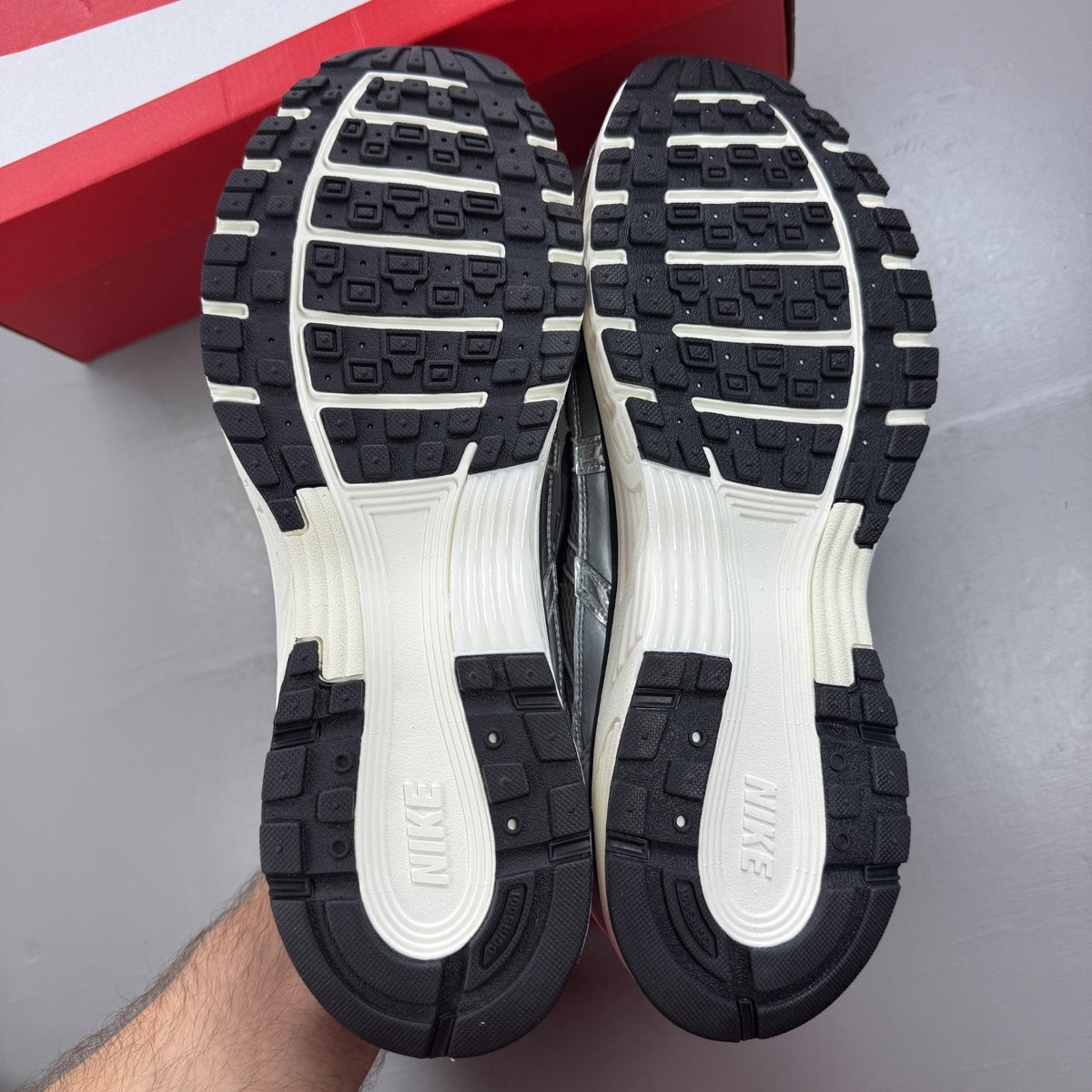 Nike deck shoes metallic silver with black and white accents, featuring logo details.