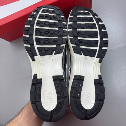 Nike deck shoes metallic silver with black and white accents, featuring logo details.