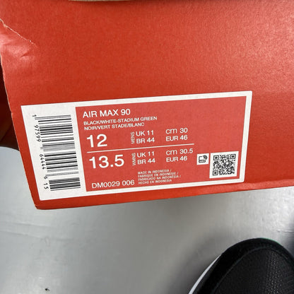 Nike Air Max 90 black trainers with stadium green accents and white sole.