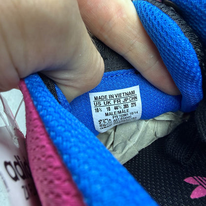 Adidas ZX Flux trainers in shock pink with black and blue accents, mesh upper.