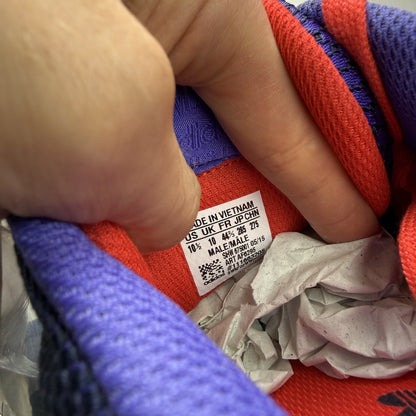 Adidas blue ZX Flux trainers with red and white woven pattern, logo on tongue.