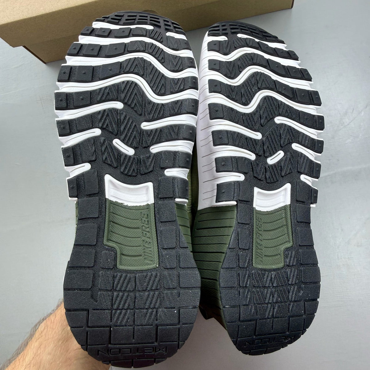 Nike green trainers with breathable mesh upper and cushioned sole.