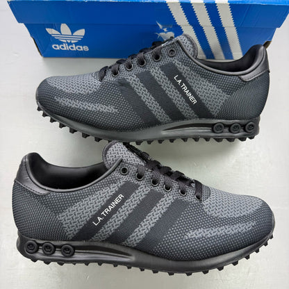 Adidas black grey LA Trainer sneakers with woven upper and iconic three-stripe logo.