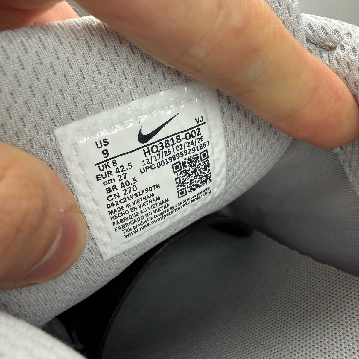 Nike grey P-6000 trainers with laser orange accents and mesh material.