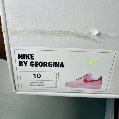 Nike deck shoes white leather with red accents and logo detail.