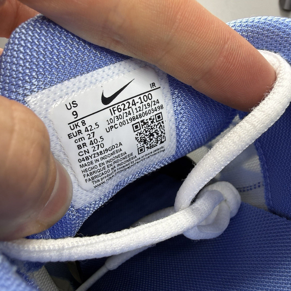 Nike Air Max Plus TN white trainers with blue and yellow accents, featuring logo detailing.