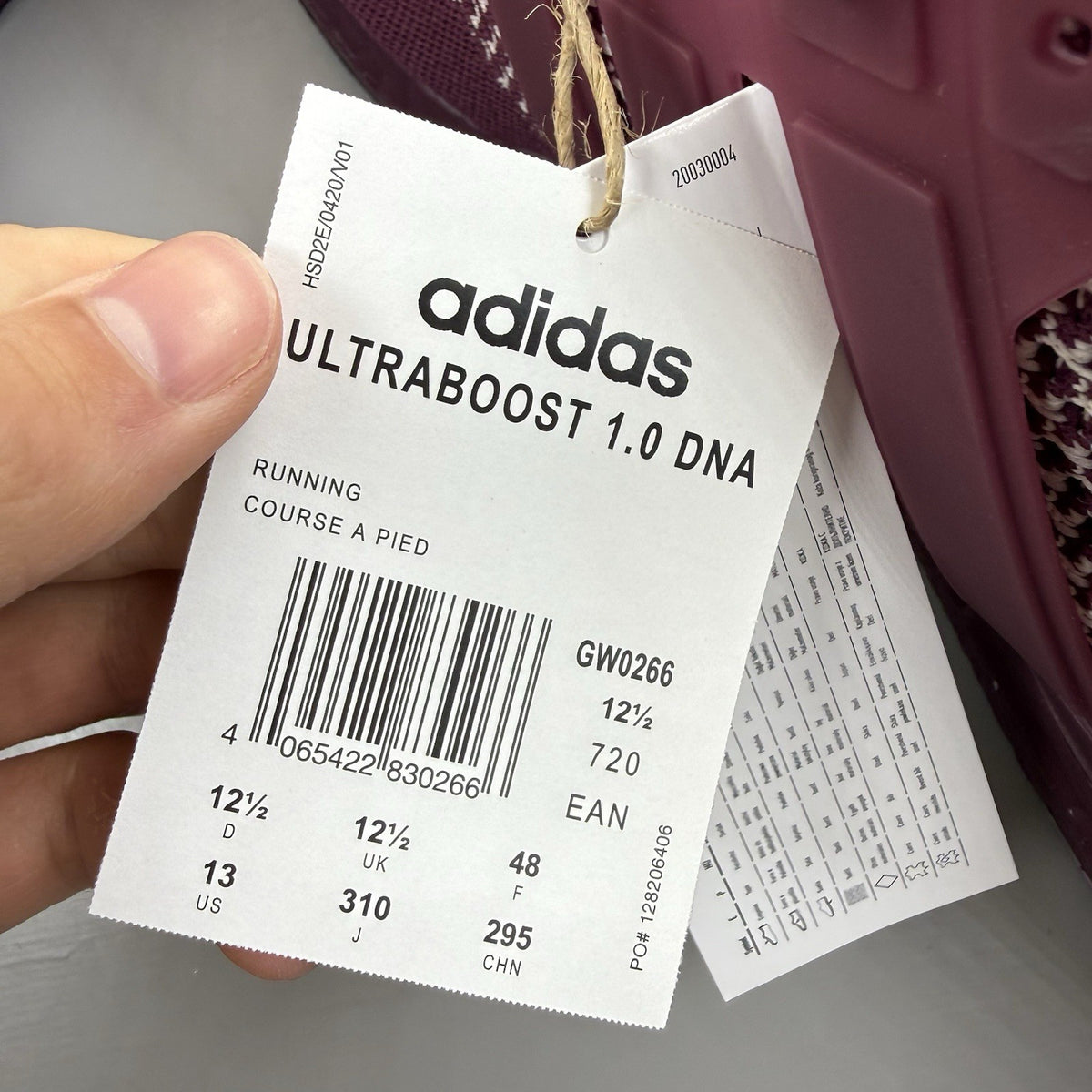 Adidas UltraBoost 1.0 DNA red trainers with signature three stripes and knit upper.