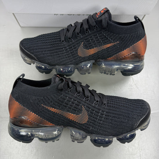 Nike Air VaporMax Flyknit 3 black trainers with total orange accents and breathable knit upper.