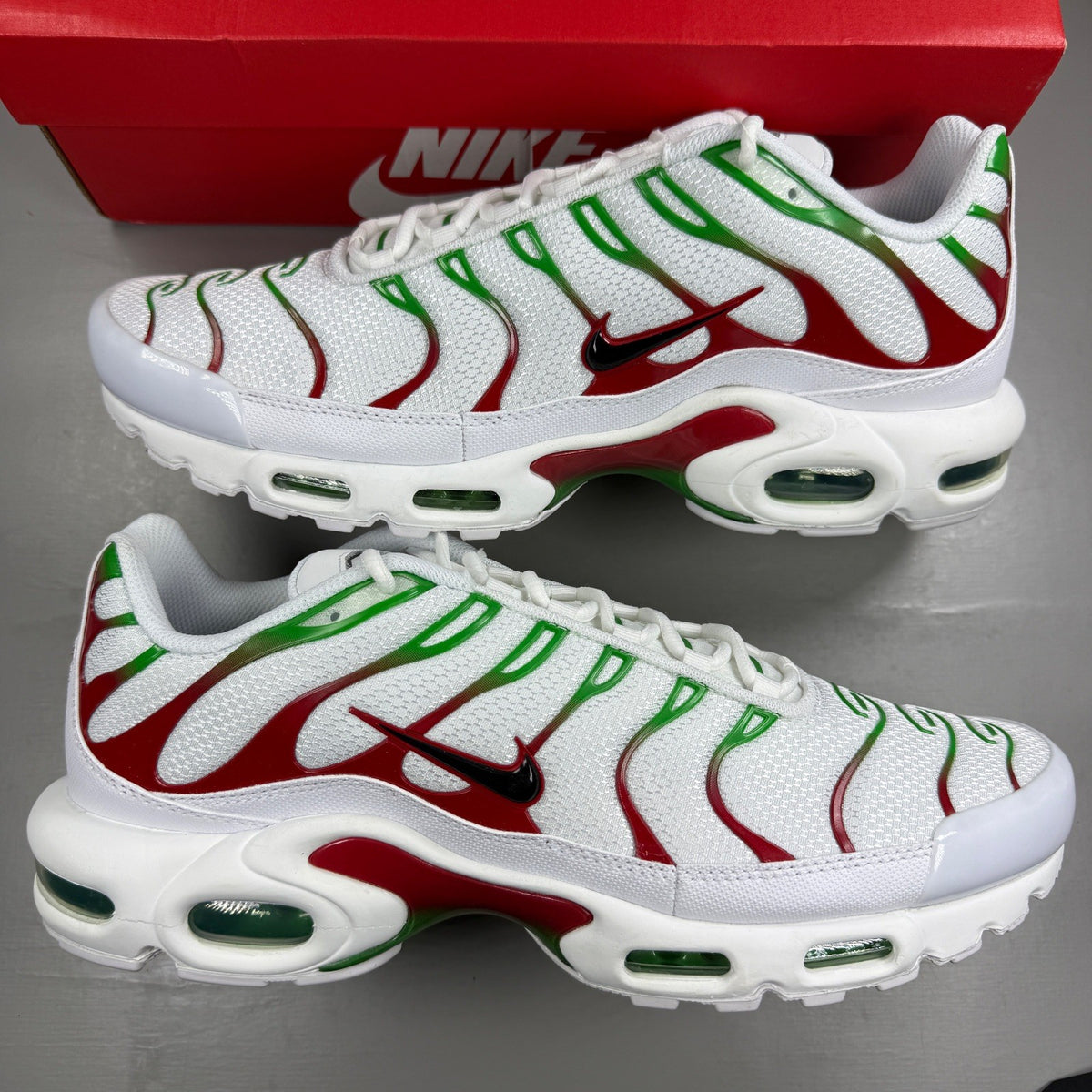 Nike deck shoes white with green and red accents, featuring logo and sleek design.
