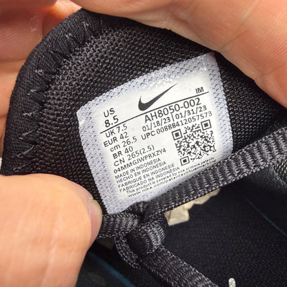 Nike Air Max 270 black trainers with white accents and logo detail.