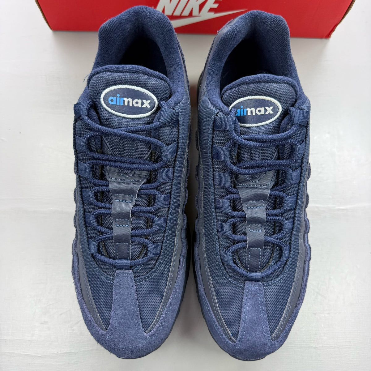 Nike Air Max 95 blue trainers with mesh upper and signature swoosh logo.