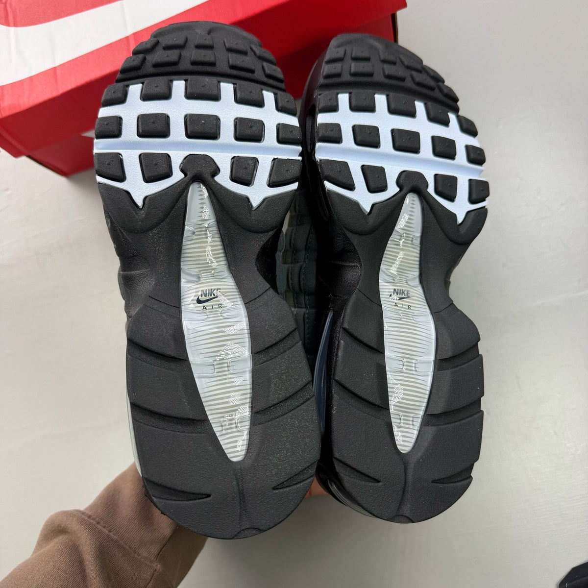 Nike Air Max 95 black trainers with big bubble design and reflective accents.