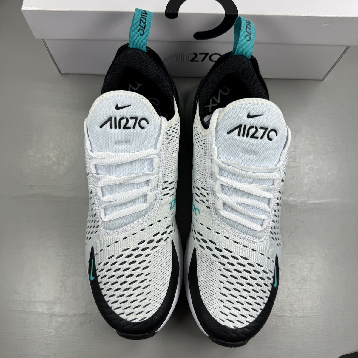 Nike deck shoes white with black accents and logo, featuring a sleek design.