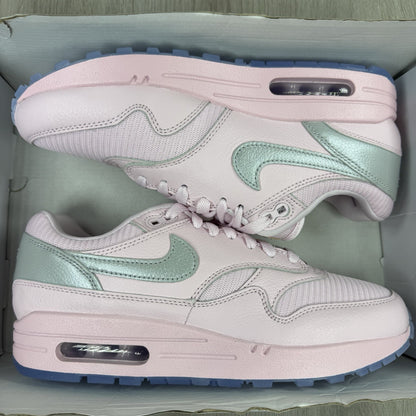 Nike Air Max 1 trainers pink with silver accents and unique design details.