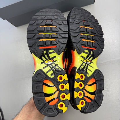 Nike Air Max Plus TN black with vibrant limelight and hyper crimson accents.